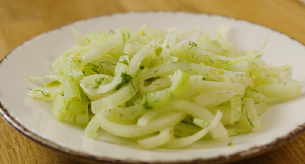 Smørdampet fennikel pent anrettet på en hvit tallerken. Foto.