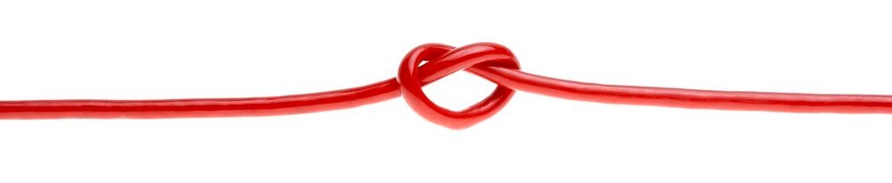 A red wire that has been tied in the shape of a heart. Photo.