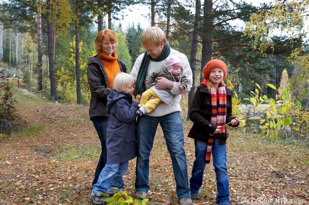 Familie på tur i skogen. Foto.