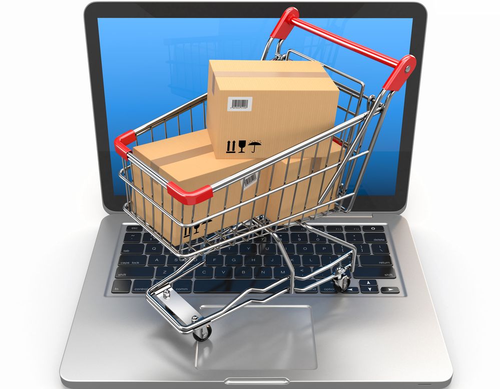 Handlevogn med pappesker plassert på tastaturet til en bærbar datamaskin. Illustrasjon.