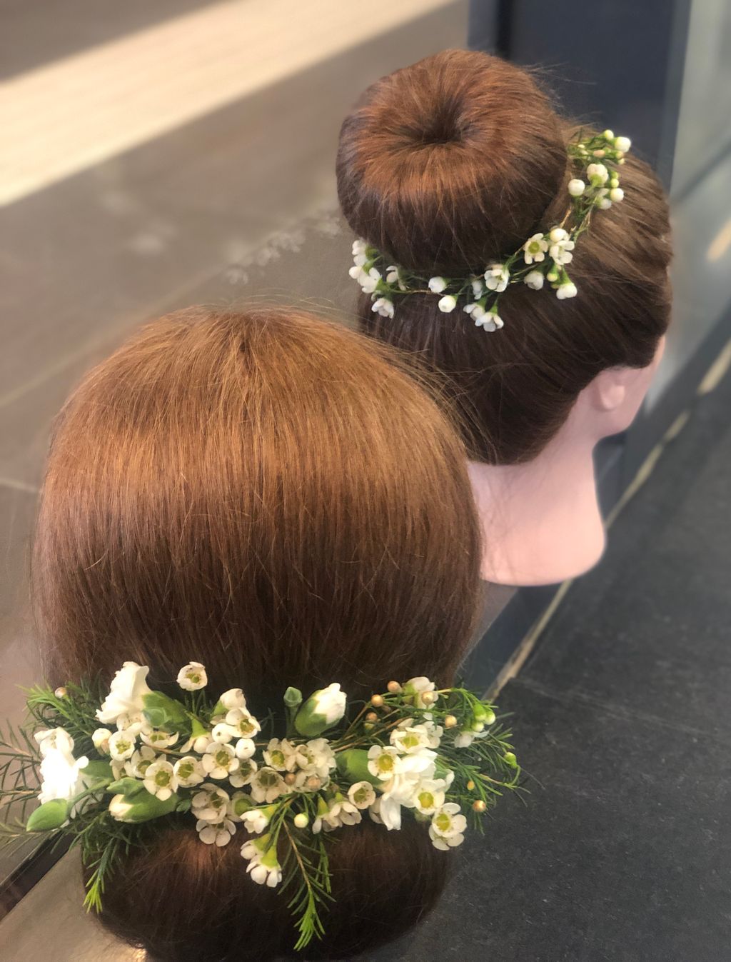 To øvingshoder med oppsatt hår og blomster. Foto. 