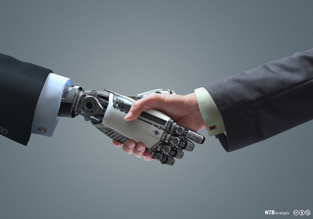 Robot og menneske håndhilser. Foto.