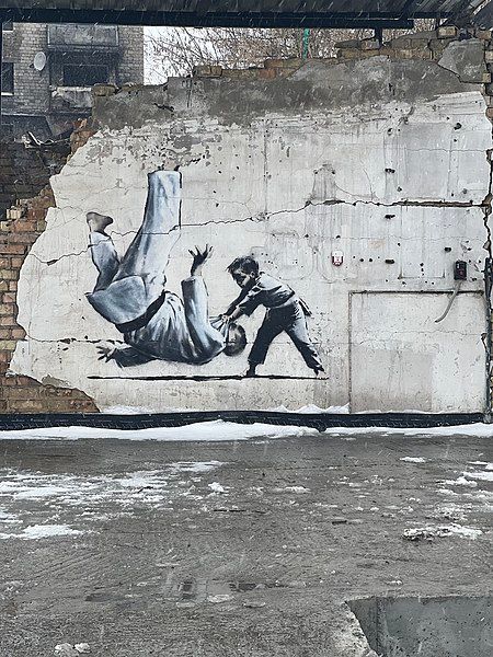 A young boy throws Putin on the ground during a judo match. Mural.