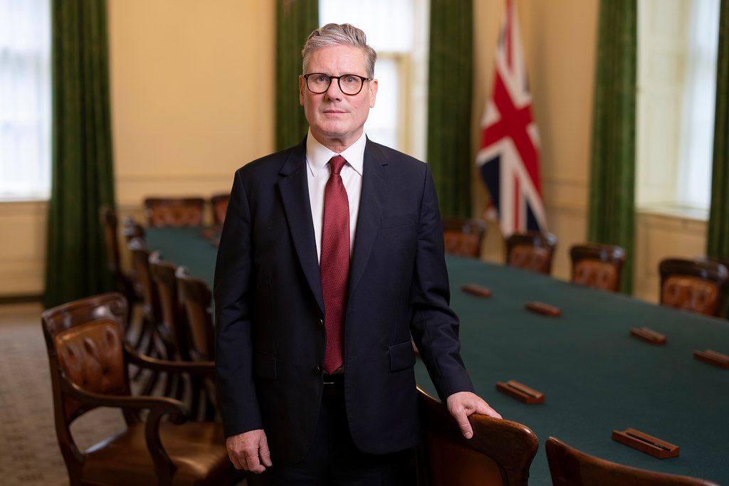 Prime Minister Keir Starmer standing in front of a Union Jack. Photo.