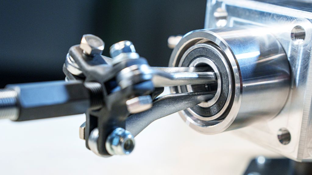 Et sylindrisk verktøy med tre bein festa i et lager. Foto.