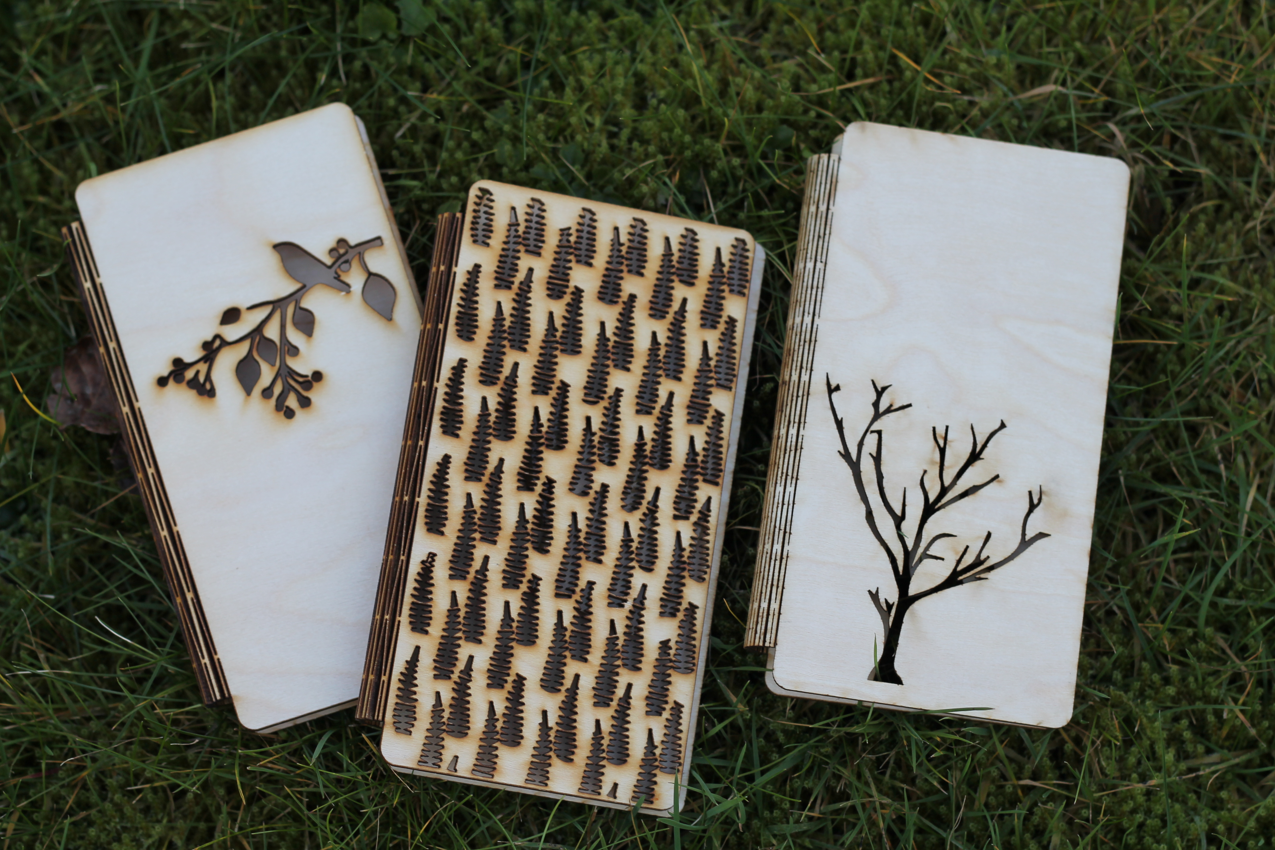 Tre mobildeksel med ulike design laget i flyfiner med tre ulike design. Foto.