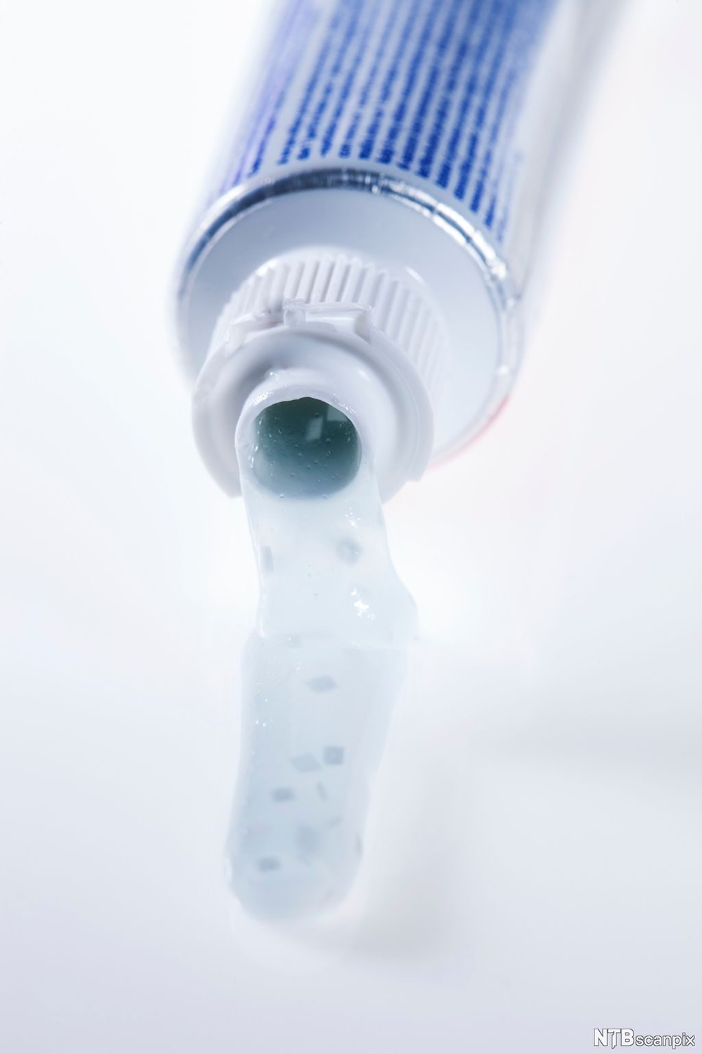 Tannkrem renner ut av tannkremtube. Foto.