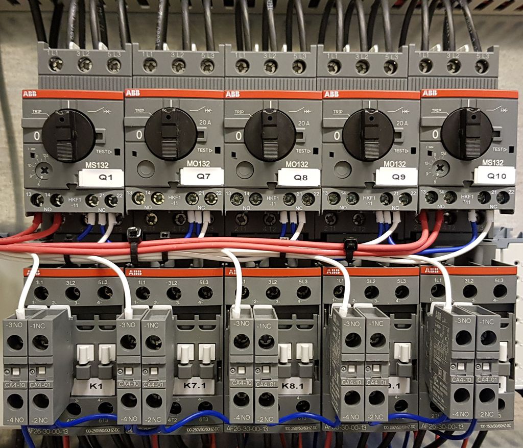 Biletet viser fleire kontaktorar med hjelpeblokker og motorvern. Det er også kopla til nokre leidningar. Foto.