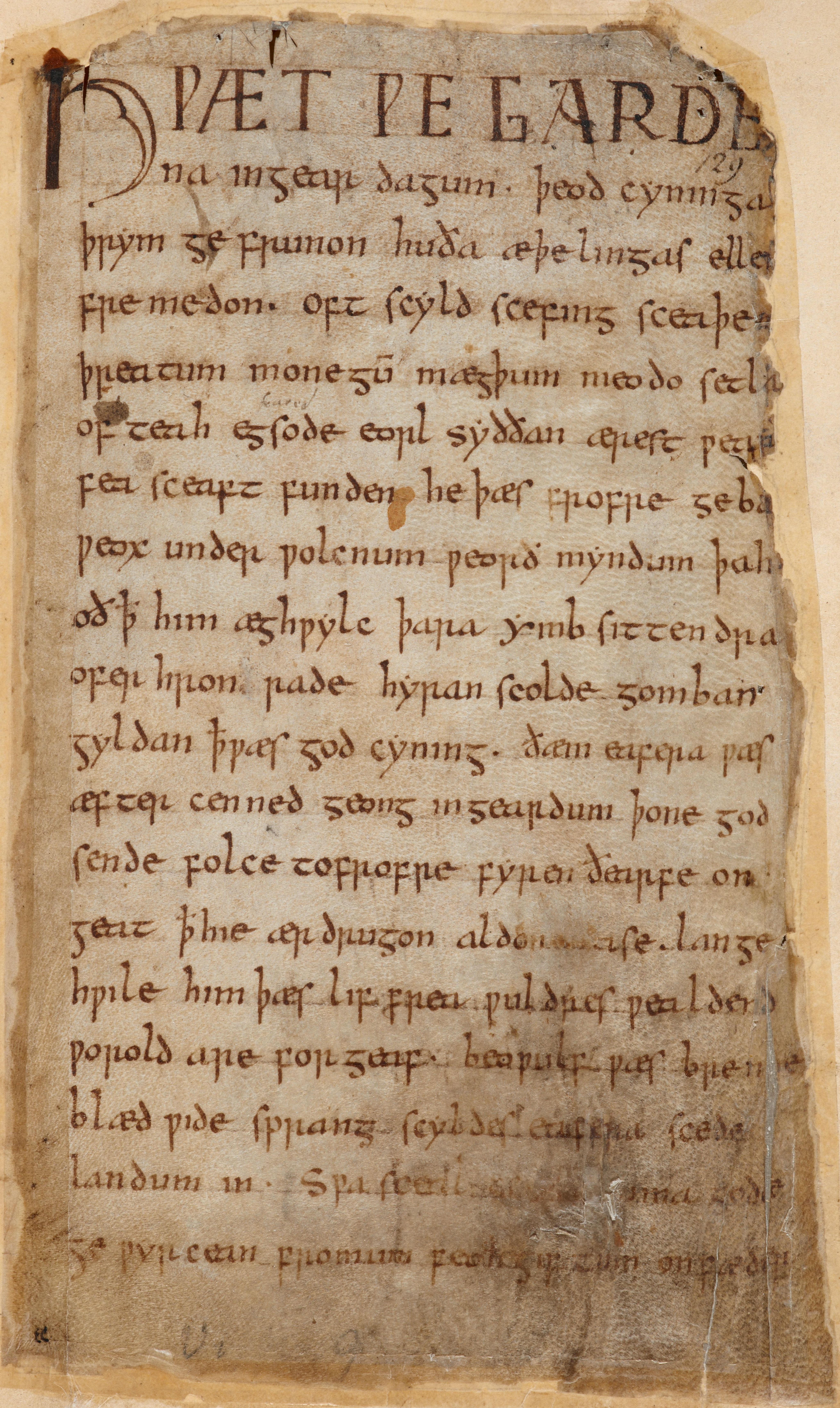 A page of parchment with writing on it. The letters and language is not like modern-day English. Photo. 