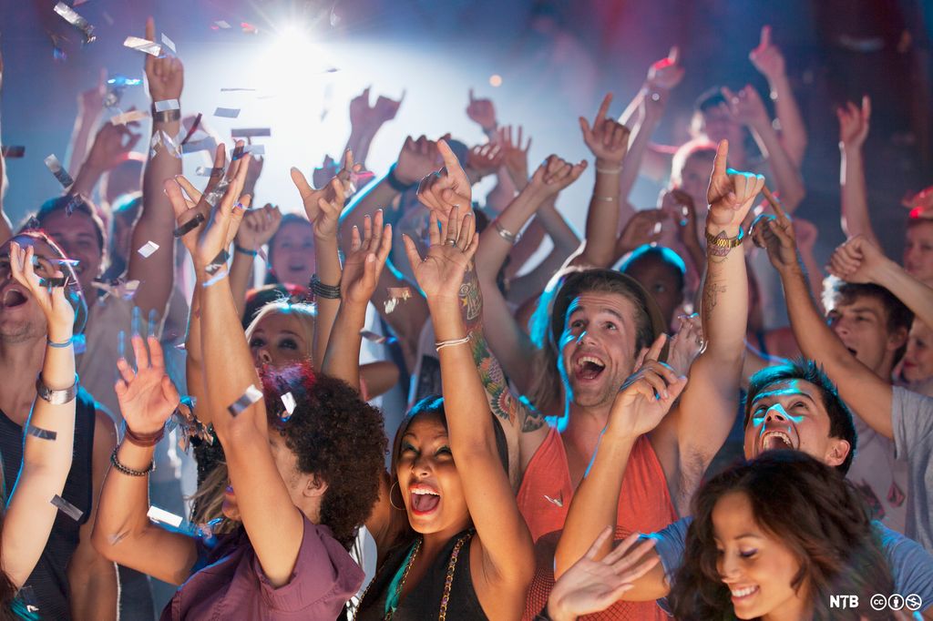 Enthusiastic crowd cheering at concert. MODEL RELEASED