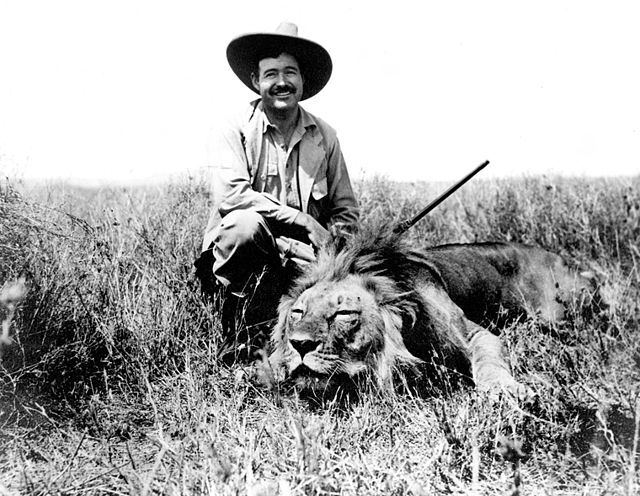 Photo: We see a man with a rifle posing next to the body of a male lion. 