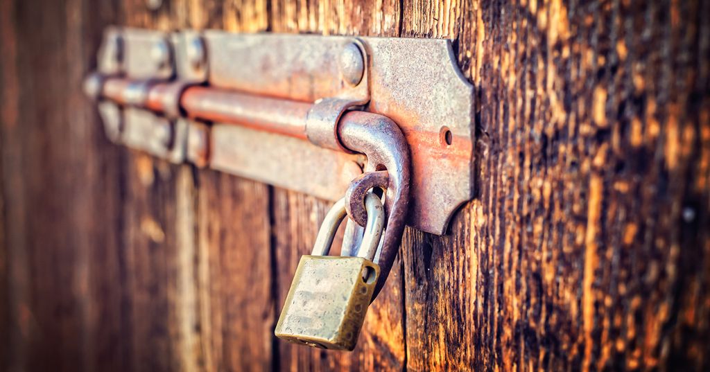 Close-up of a an old latch of an old wooden door.