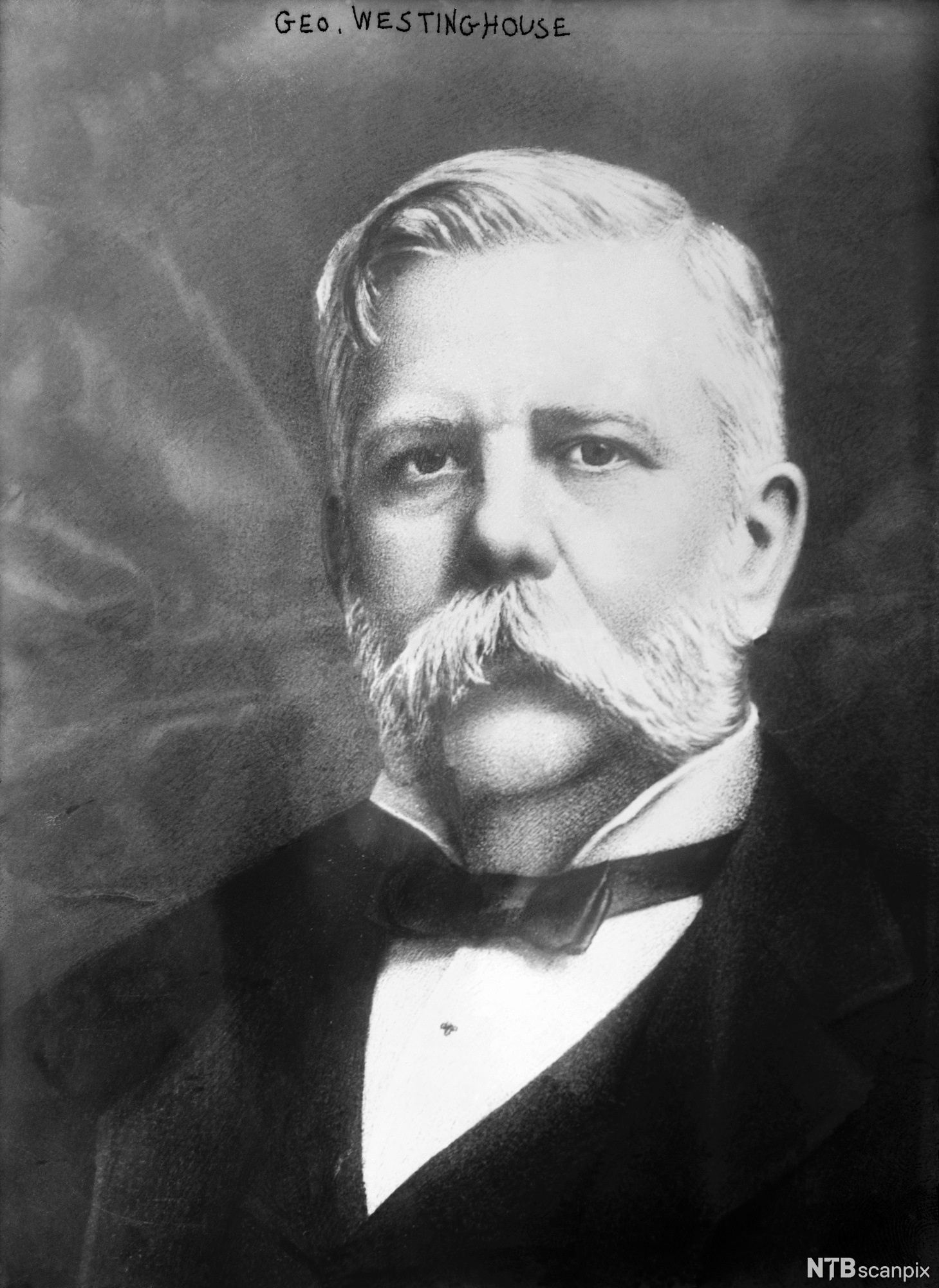 Photo: Portrait of George Westinghouse. We see a man with white hair, sideburns and a large moustache. He is wearing a dark suit, white shirt and a bow tie. 
