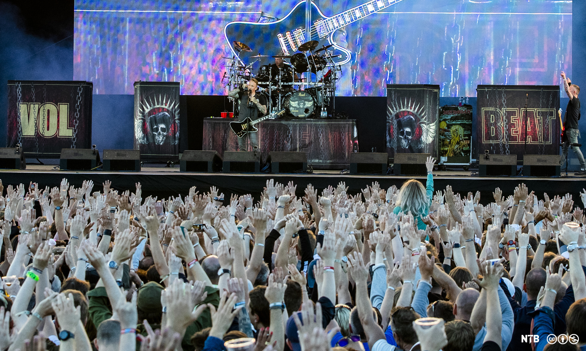 Publikum står med hendene i været foran scenen mens Volbeat spiller på Tons of Rock på Ekeberg. Foto.