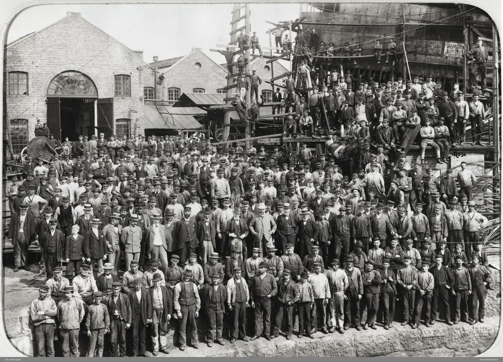 Mange arbeidarar stilt opp til fotografering ved Akers Mekaniske Verksted i 1898. Her er òg funksjonærar i litt finare klede. Foto. 