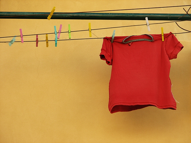 A red t-shirt on a washing line. Photo.