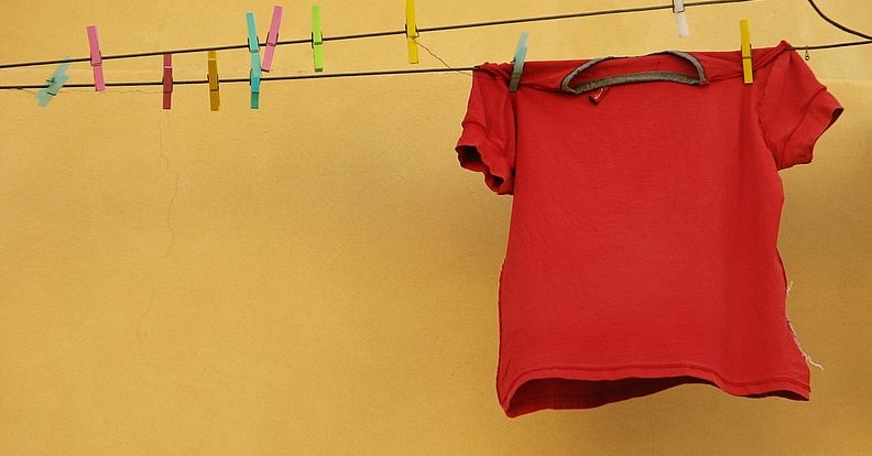 A red t-shirt on a washing line. Photo.
