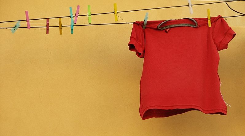 A red t-shirt on a washing line. Photo.