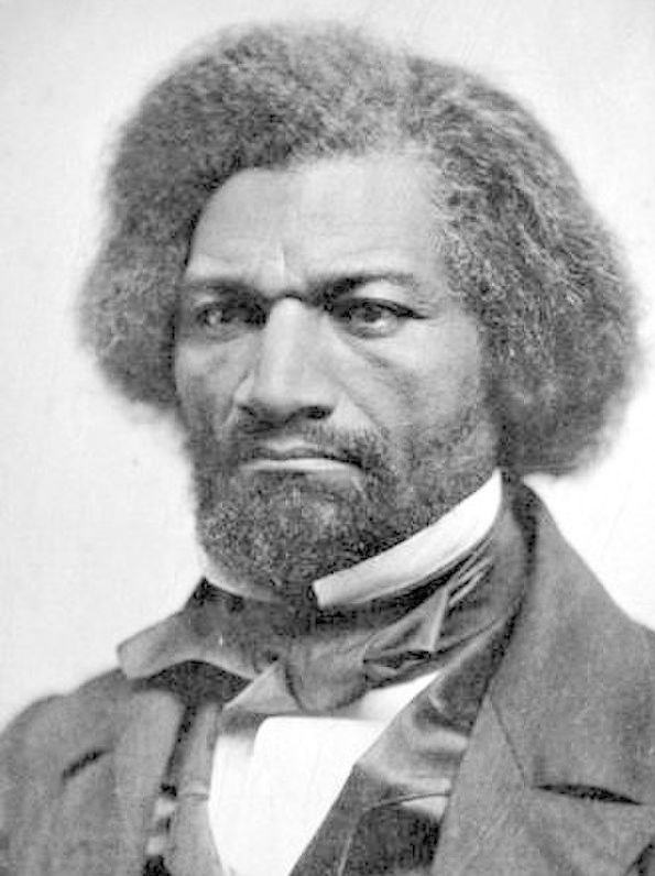 Portrait of Fredrick Douglass. He is a Black man dressed in a suit and a bow. He has thick hair and a beard. His expression is sad, or even angry. Black and white photo.