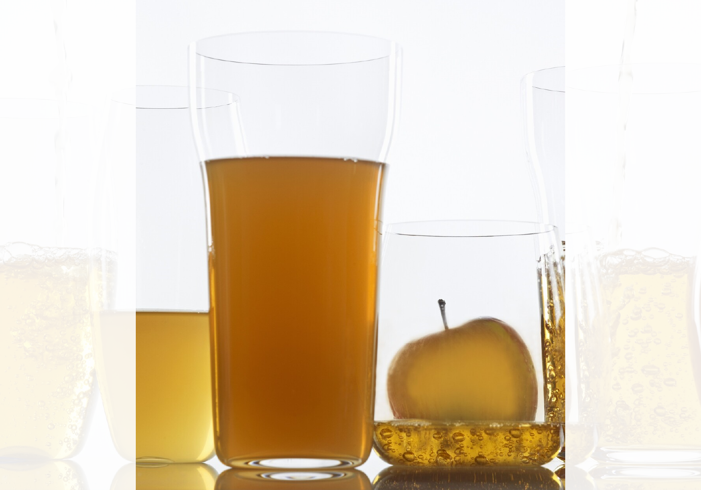 Flere glass med brunaktig væske. Innholdet i noen av glassene er klarere enn andre. Foto.