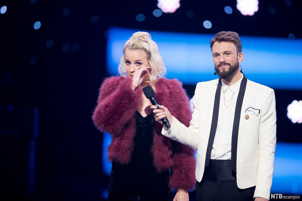 Programleder Kåre Magnus Bergh i Stjernekamp holder mikrofonen bort til deltaker Nicoline Berg Kaasin. Foto.