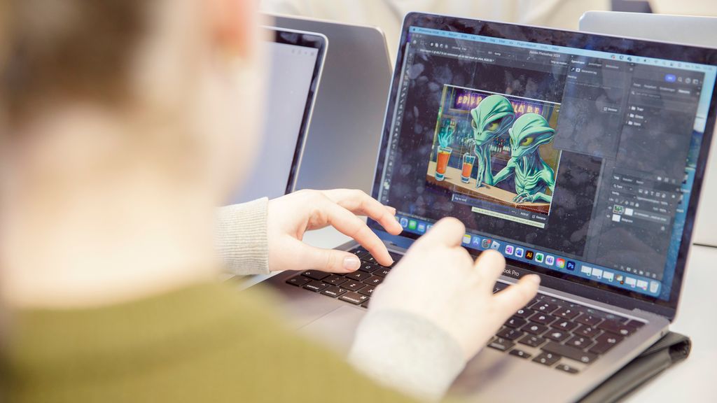 Ein elev genererer eit KI-foto på ein pc. Foto.