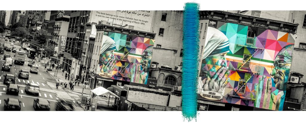 A large, colorful mural in New York displays facing portraits of Mother Theresa and Gandhi, who appear to be looking at each other. Photo.