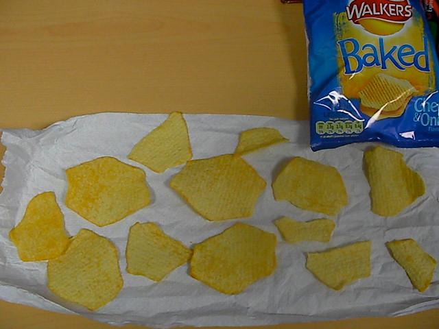 Crisps and a packet of chips. Photo.