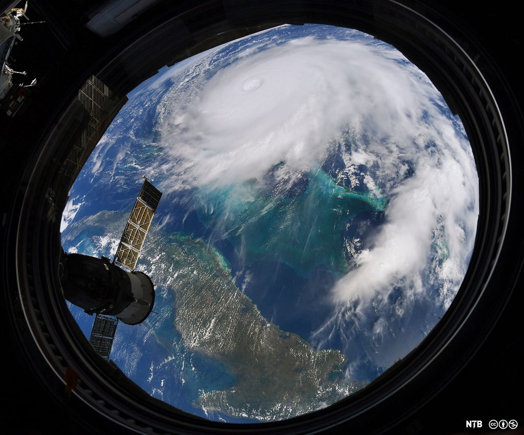 The Earth seen from a structure in space. A hurricane moving towards a land mass. Photo.