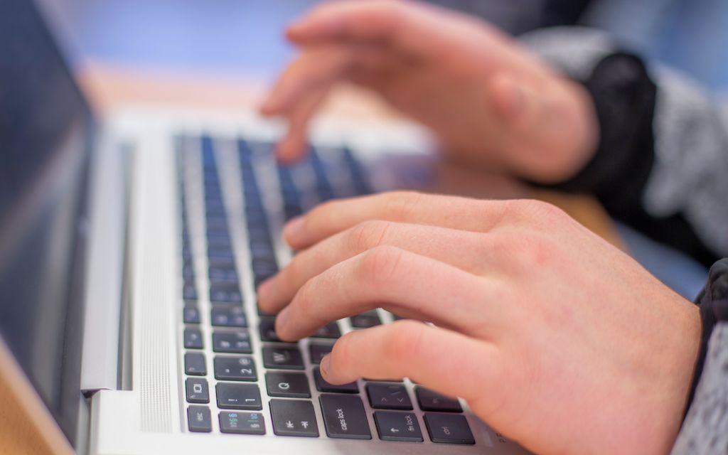 Two hands writing on a keyboard. Photo. 