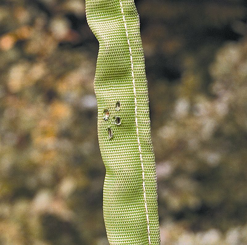 Slitt, grønn fiberstropp. foto.