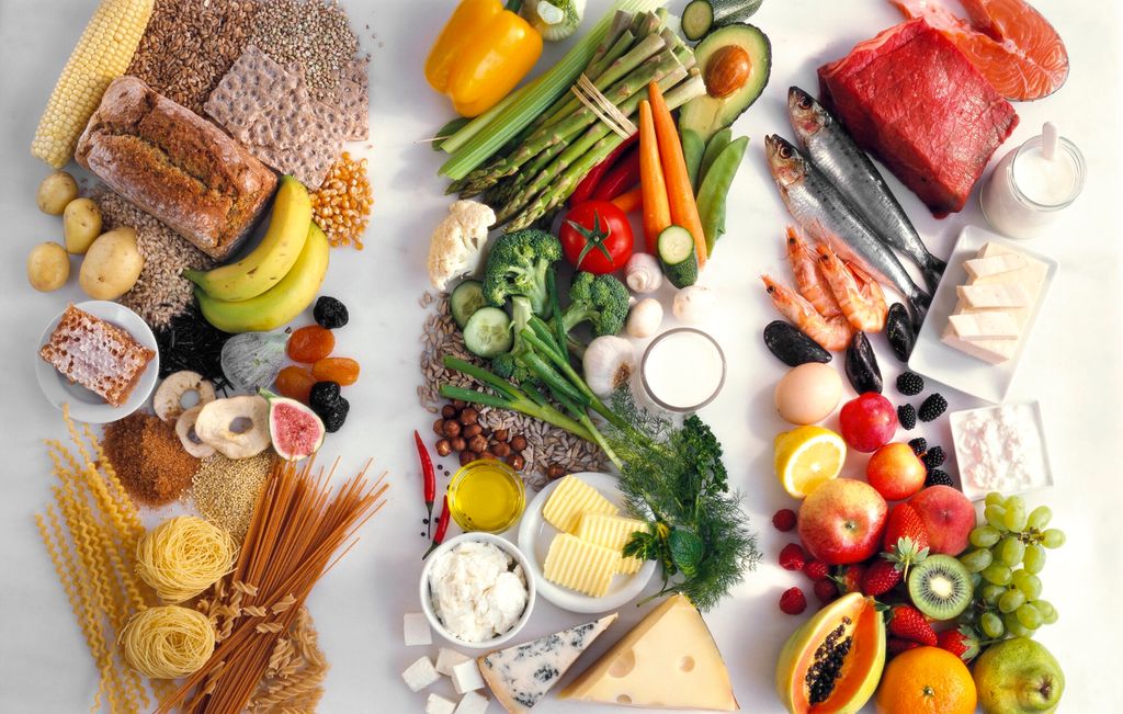 Et utvalg råvarer ligger i tre rekker. Korn, grønnsaker, frukt, kjøtt, fisk og meieriprodukter er representert. Foto.