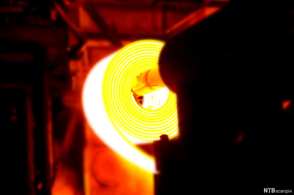 Glødende stål valses og rulles sammen. Foto.