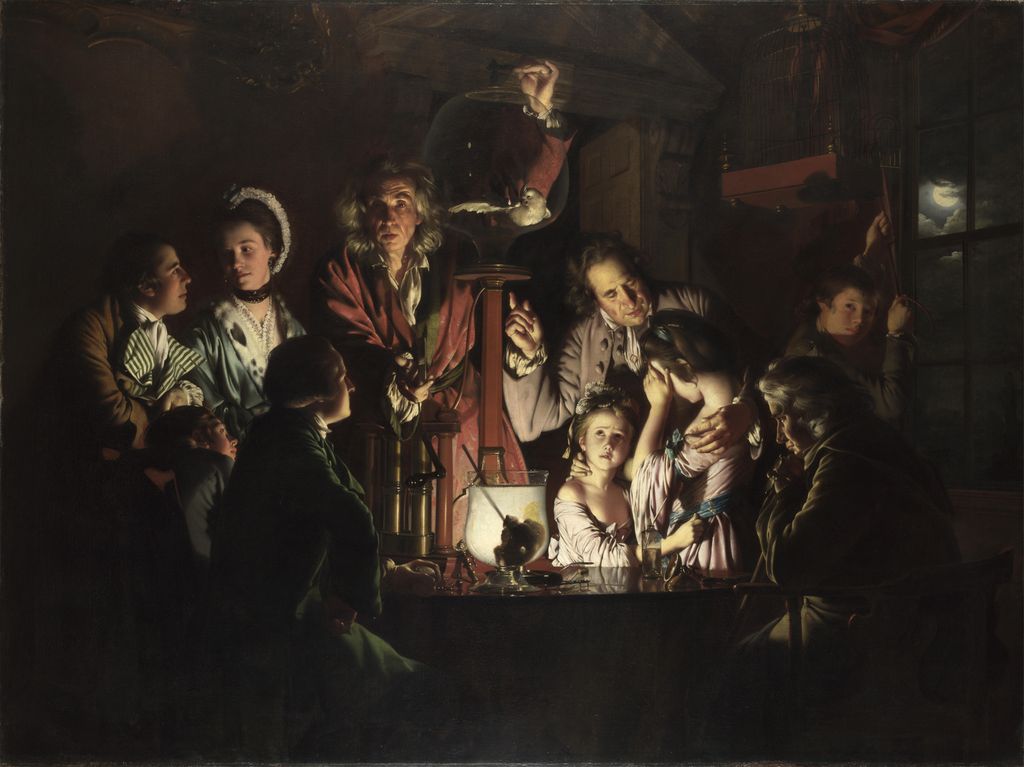 Painting: A group of people are gathered around watching an experiment. The room around them is dark. They appear to be lit up by light coming from the apparatus used in the experiment. Women, men and children are present. Most appear to be dressed in a lavish, expensive style. 