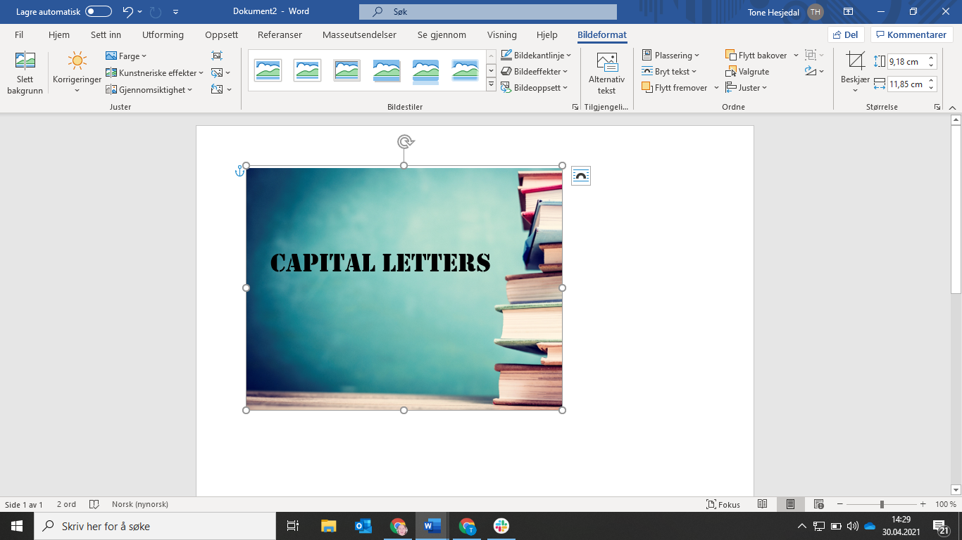 Illustration: The words CAPITAL LETTERS  on a blue background. On the right the edge of a pile of books is seen. 