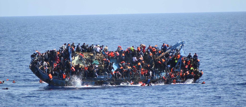 An overcrowded refugee boat capsizes in the Mediterranean Sea. Photo.