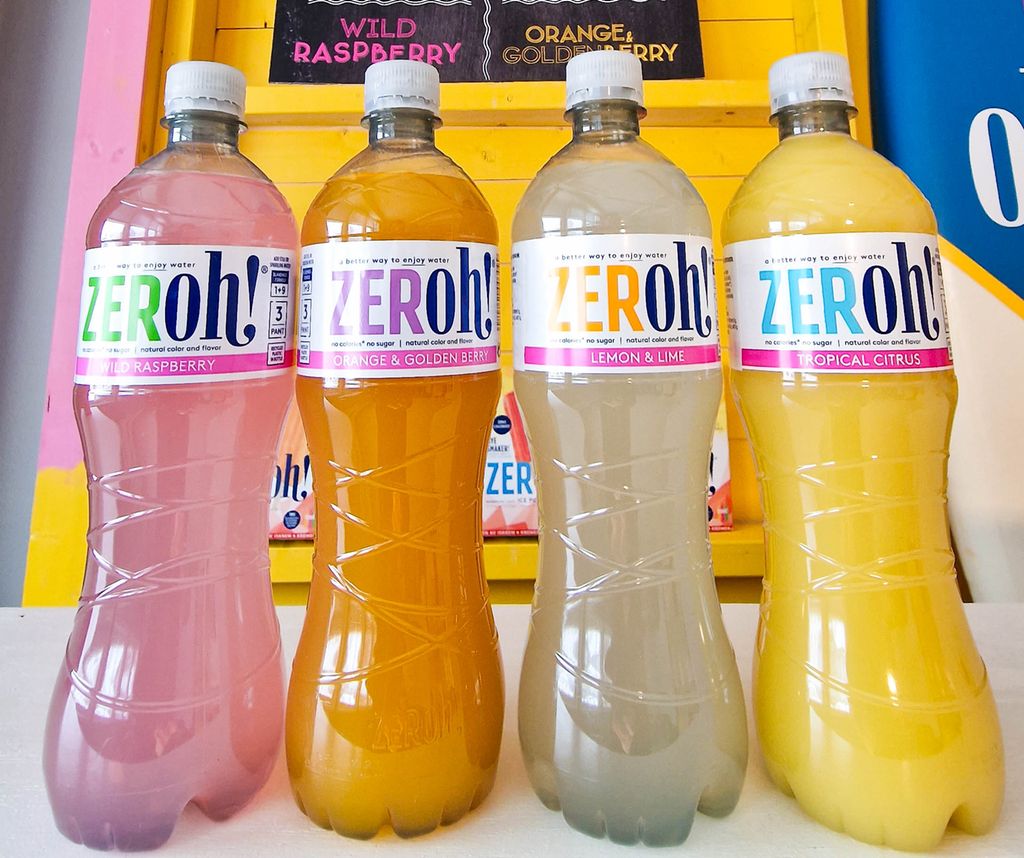 Fire Zeroh! saftflasker med ulike smaker. Innholdet i flaskene er i friske nyanser av rosa og gult. Foto.