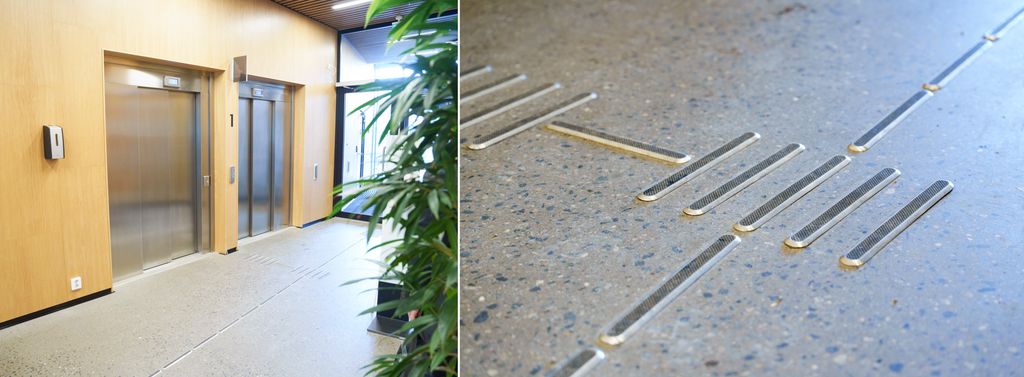 Inngangsparti med to heiser og gulvmerking. Foto.