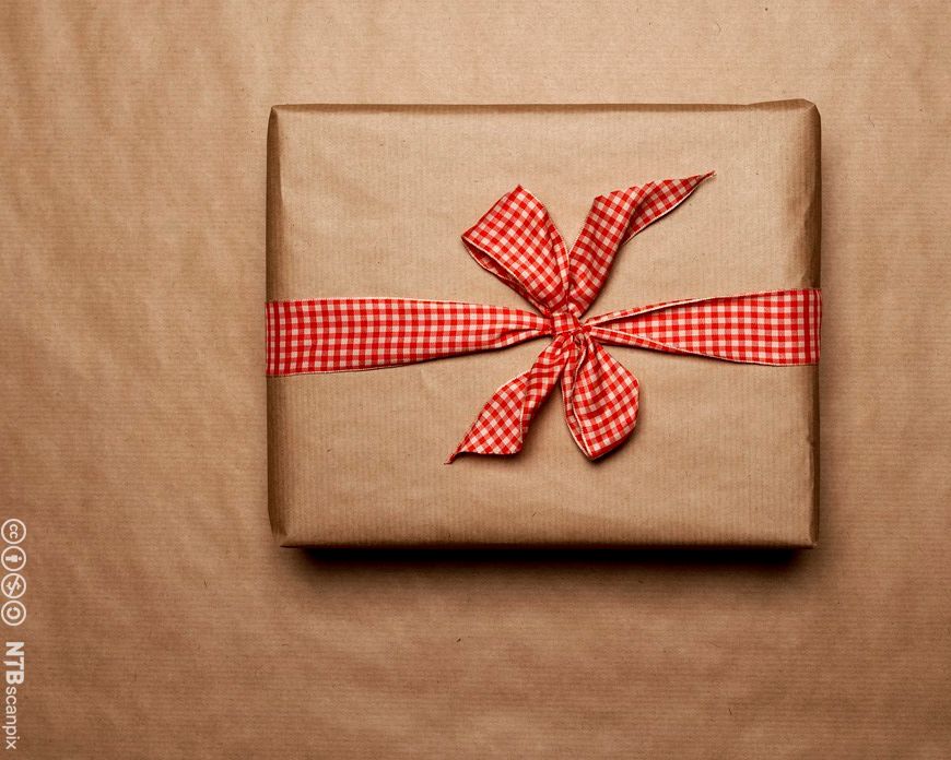 Photo: Gift wrapped in brown paper. It has a red and white bow.