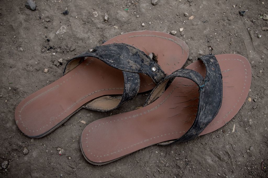 Et par slitte sandaler på grusen. Foto. 