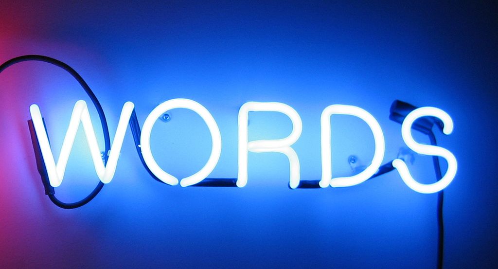 The word "words" in neon lights on a blue background