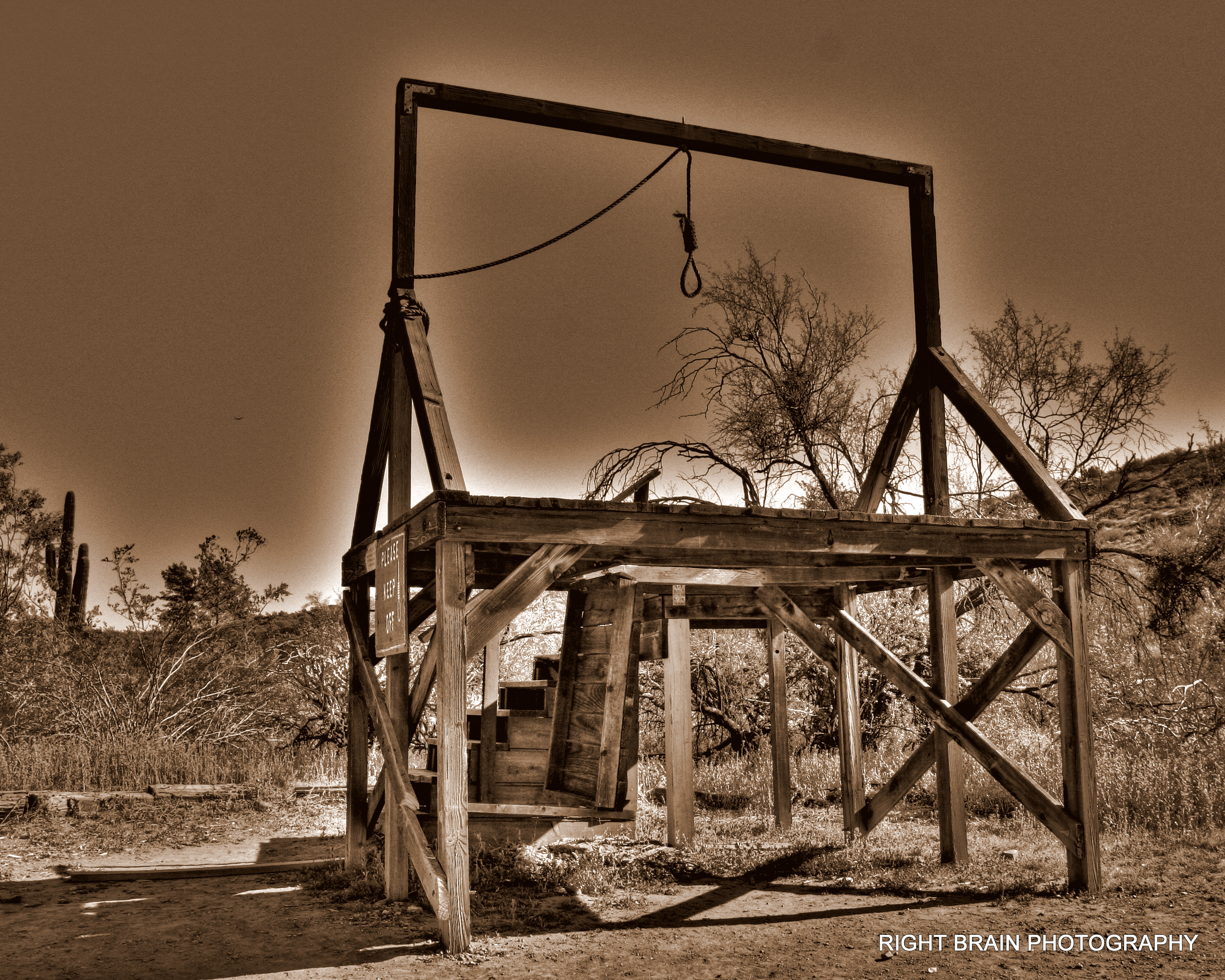 A primitive gallows of the type used in the Wild West. The photo has been colour manipulated into different brownish colours.