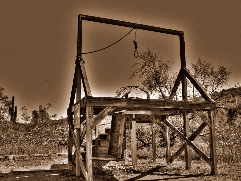 A primitive gallows of the type used in the Wild West. The photo has been colour manipulated into different brownish colours.