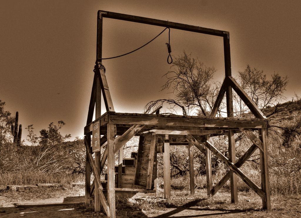 A primitive gallows of the type used in the Wild West. The photo has been colour manipulated into different brownish colours.