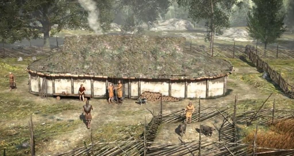 Langhus med mennesker og noen dyr i innhegning utenfor. Skjermbilde fra animasjon om Steinalderen.