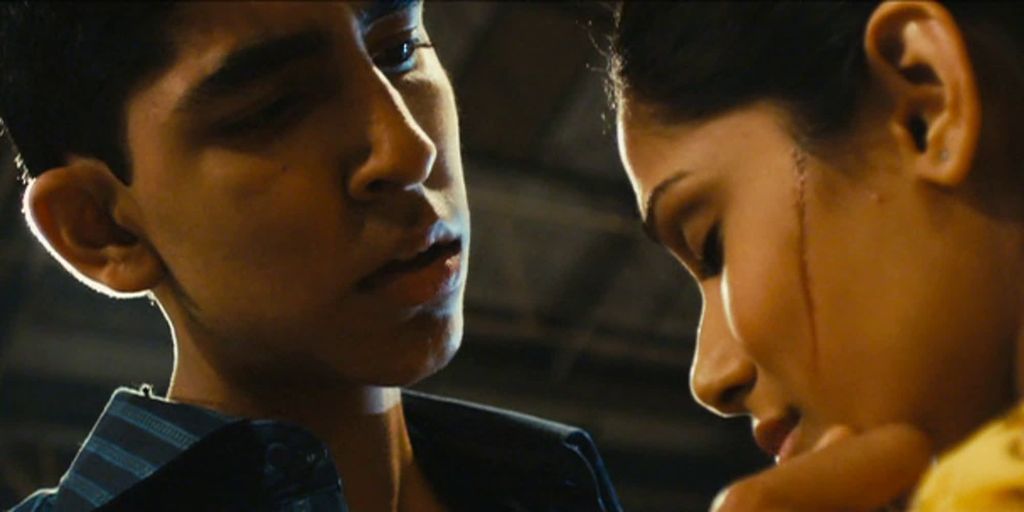 Jamal and Latika in 'Slumdog Millionaire'. Jamal is comforting Latika, who is crying. Photo.