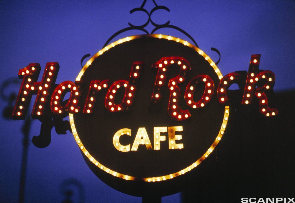 Hard Rock Café sign in lights at night. Photo.