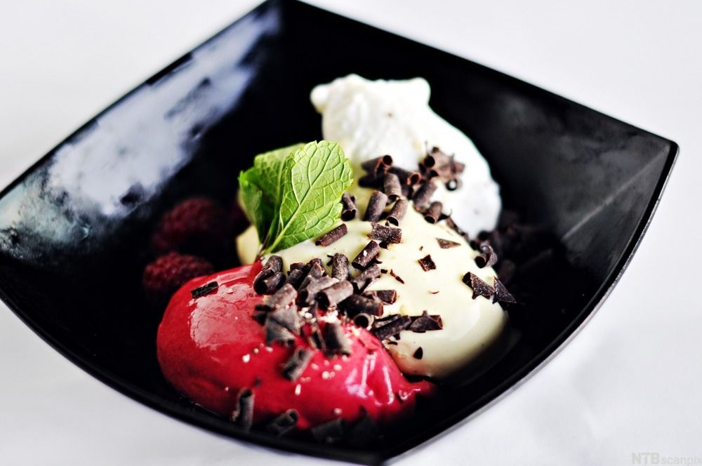 Iskrem og sorbet servert i en sort dessertskål. Foto.