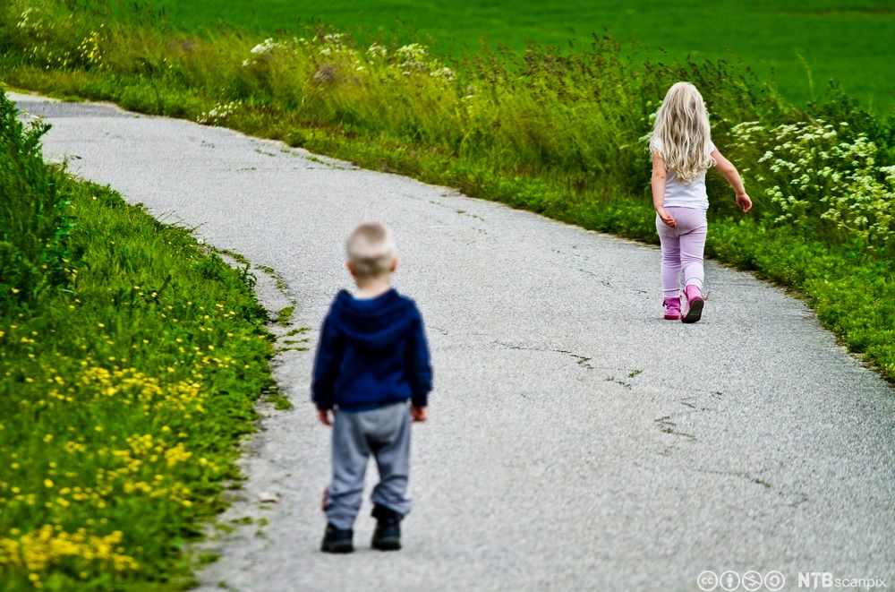 Lita jente som går fra liten gutt. Foto.