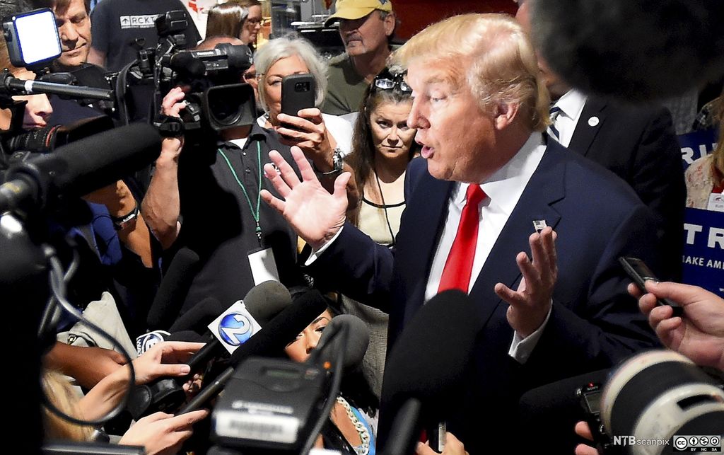 Den republikanske presidentkandidaten Donald Trimp omgjeven av mikrofonar og kamera. Foto.